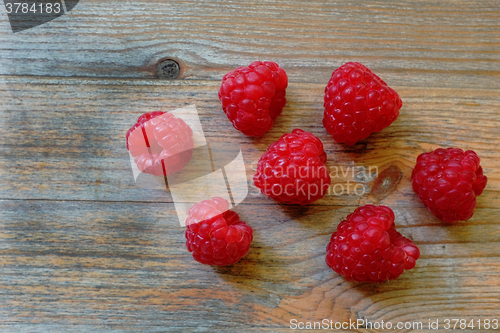 Image of fresh red berries Raspberry European on a wooden surface