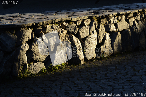 Image of low stone wall and cobblestones