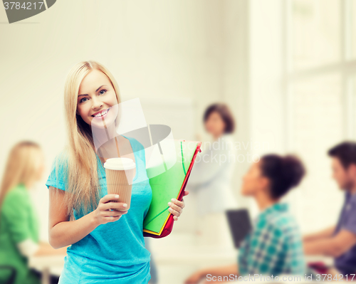 Image of smiling student with folders