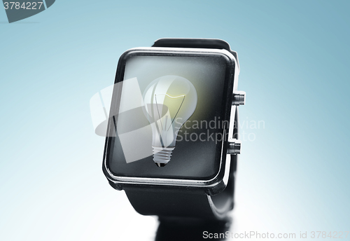 Image of close up of black smart watch with light bulb