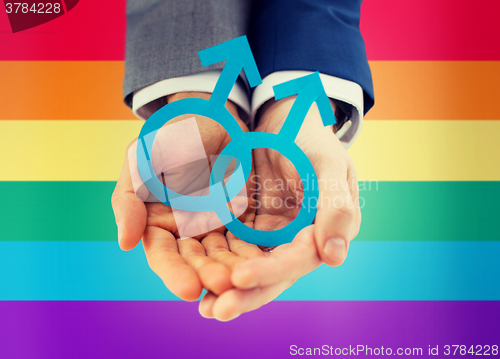 Image of close up of happy male gay couple with love symbol