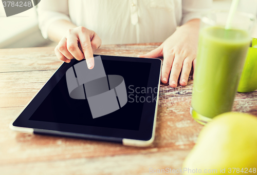 Image of close up of woman hands tablet pc and fruit juice