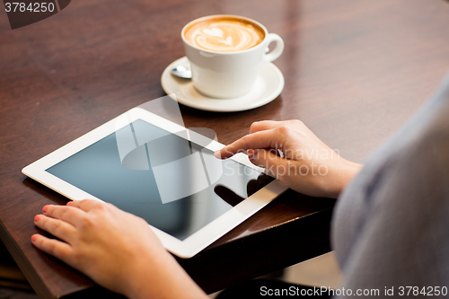 Image of close up of woman with tablet pc and coffee