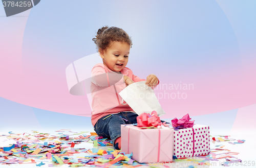 Image of happy little baby girl with birthday presents