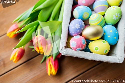 Image of close up of colored easter eggs and flowers