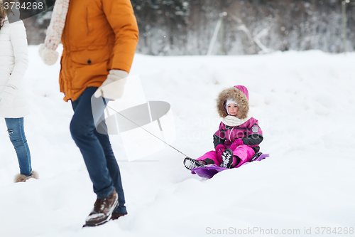 Image of happy family with sled walking in winter forest