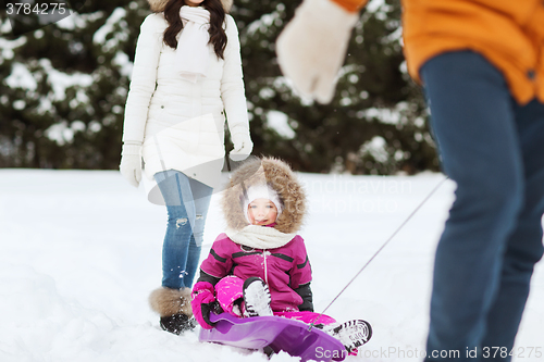 Image of happy family with sled walking in winter forest