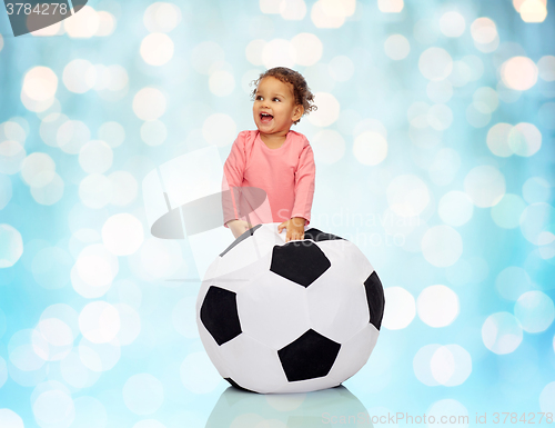 Image of happy mulatto little baby girl playing with ball