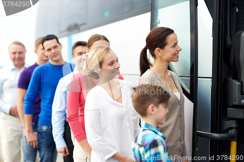 Image of group of happy passengers boarding travel bus