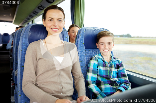 Image of happy family riding in travel bus