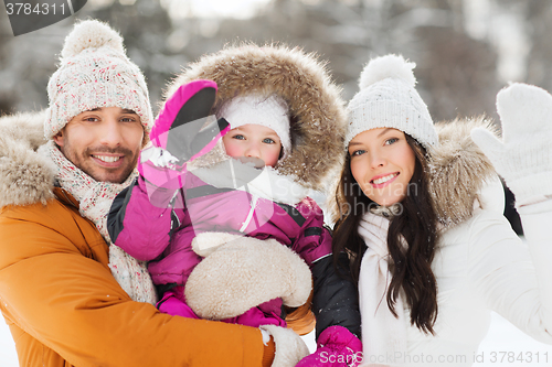 Image of happy family waving hands outdoors in winter