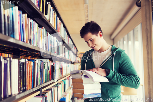 Image of happy student or man with book in library