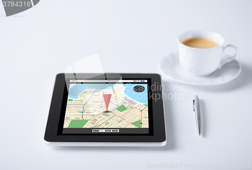 Image of tablet pc with gps navigator map and cup of coffee