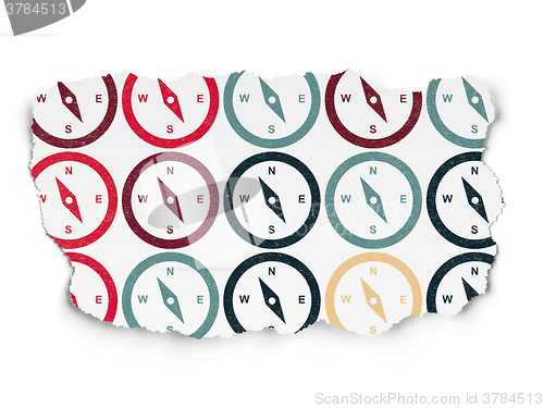 Image of Vacation concept: Compass icons on Torn Paper background