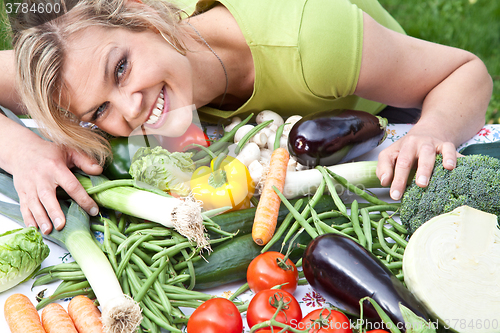 Image of Cute blond girl with vegetables