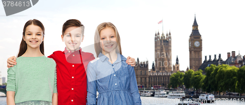 Image of happy boy and girls hugging over london