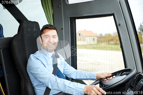 Image of happy driver driving intercity bus