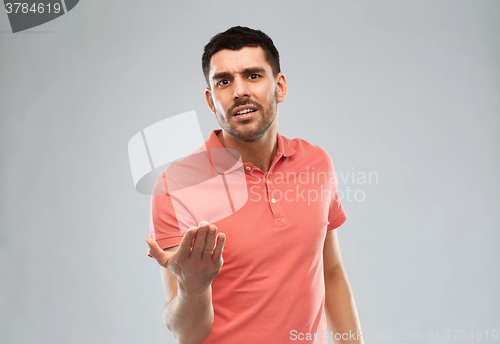 Image of arguing man proving something over gray