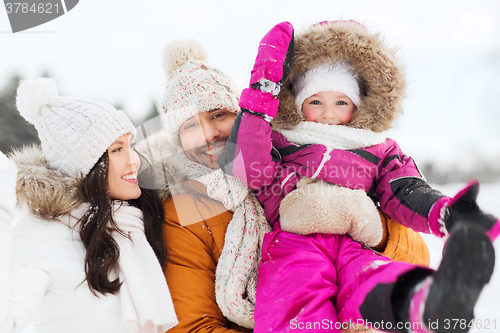 Image of happy family with child in winter clothes outdoors