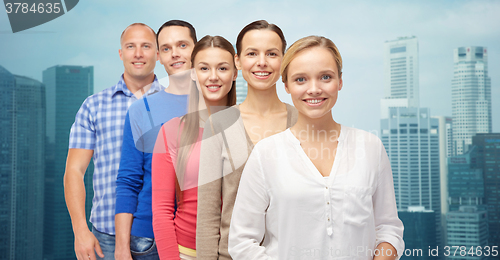 Image of group of smiling people over city buildings