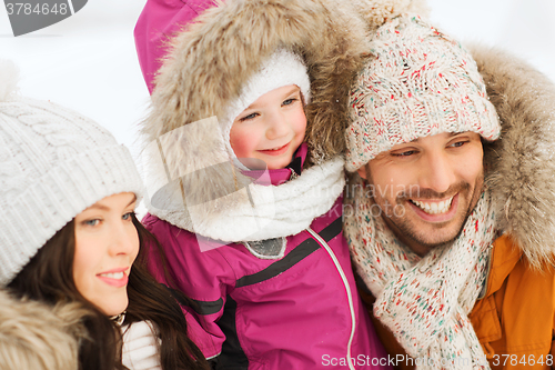 Image of happy family with child in winter clothes outdoors