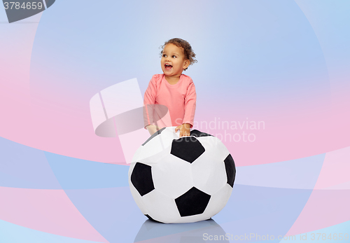 Image of happy mulatto little baby girl playing with ball