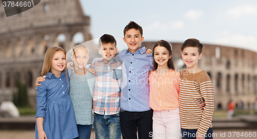 Image of smiling children hugging over coliseum in rome