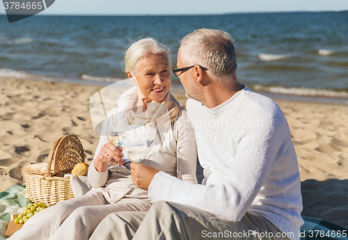 Image of happy senior couple talking on summer beach