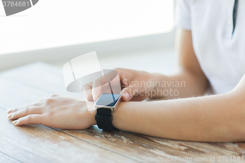 Image of close up of hands setting smart watch