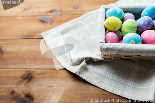 Image of close up of colored easter eggs in basket