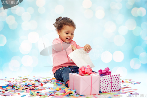 Image of happy little baby girl with birthday presents