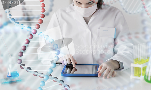 Image of close up of scientist with tablet pc in laboratory