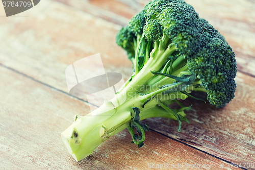 Image of close up of broccoli on wooden table