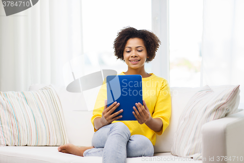 Image of happy african american woman with tablet pc