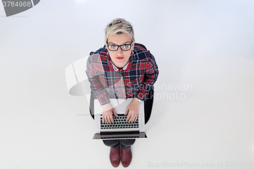 Image of top view of young business woman working on laptop computer