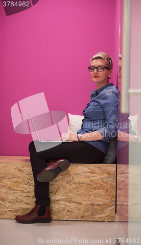 Image of woman in crative box working on laptop