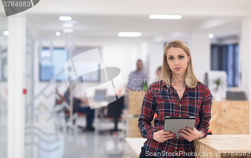 Image of portrait of young business woman at office with team in backgrou