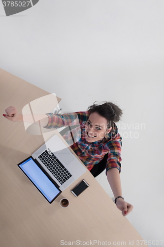 Image of top view of young business woman working on laptop
