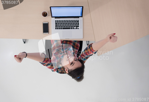 Image of top view of young business woman working on laptop