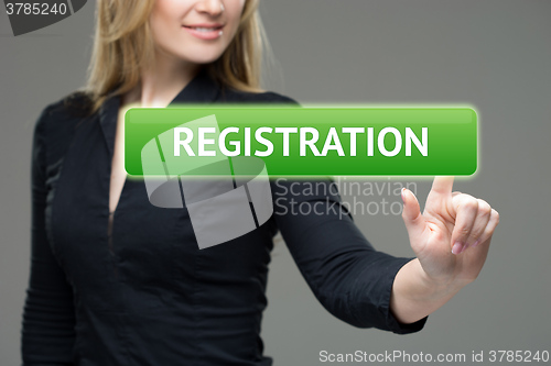 Image of business, technology, internet and networking concept - woman pressing registration button on virtual screens