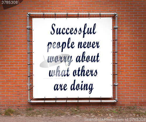 Image of Large banner with inspirational quote on a brick wall