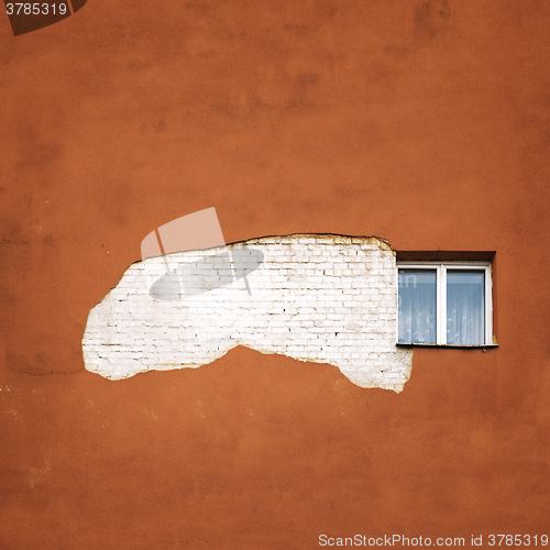 Image of abandoned cracked brick  wall with a window