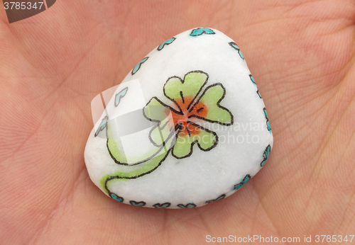 Image of Stone with drawing of a clover four and small hearts