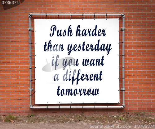 Image of Large banner with inspirational quote on a brick wall