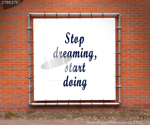 Image of Large banner with inspirational quote on a brick wall