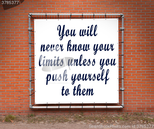 Image of Large banner with inspirational quote on a brick wall