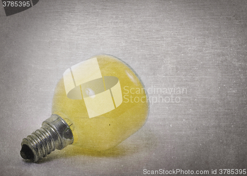 Image of Old yellow lightbulb isolated on a white background