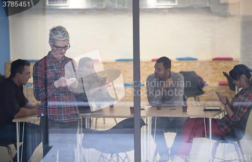 Image of business woman in meeting room  speaking by cell phone