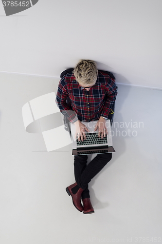 Image of top view of young business woman working on laptop computer