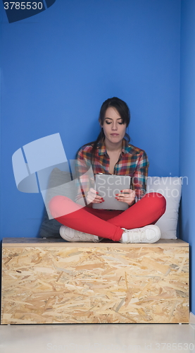 Image of woman in crative box working on tablet